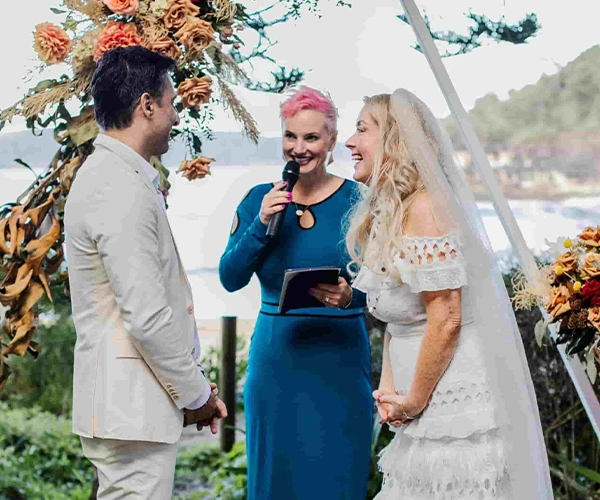 Lucy Suze Celebrant conducting a Wedding by the water in a Bay